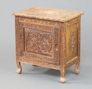 A Burmese carved hardwood cabinet enclosed by a panelled door, raised on cabriole supports 48cm h x 45cm w x 29cm d (some sun bleaching) 