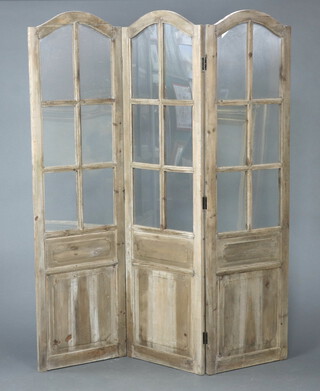 A wooden arched and glazed 3 fold screen 181cm h  
