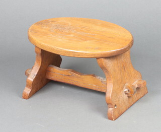 An oval oak stool raised on outswept supports with H framed stretcher 21cm h x 34cm w x 23cm d (water stain to the top) 