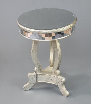 A circular bevelled glass occasional table raised on silver painted shaped supports with triform base 63cm h x 48cm diam. 