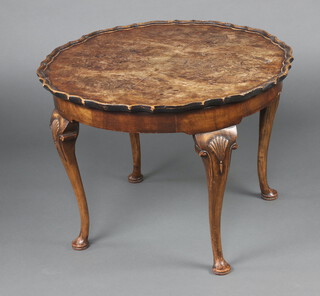 A Queen Anne style quarter veneered circular walnut coffee table with pie crust edge raised on cabriole supports 54cm h x 75cm diam. 