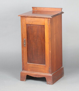 An Edwardian mahogany pot cupboard with raised back enclosed by a panelled door, on bracket feet 80cm h x 41cm w x 35cm 