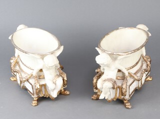 A pair of resin Empire style boat shaped planters supported by cherubs 16cm h x 28cm w x 14cm d 