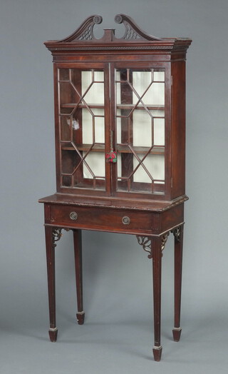 A Chippendale style mahogany display cabinet, fitted shelves enclosed by astragal glazed panelled doors, the base fitted a drawer, on square tapered supports, spade feet 193cm h x 177cm w x 41cm d (sections of timber missing in places)