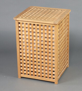 A pierced and slatted hardwood laundry basket with hinged lid 63cm x 46cm x 47cm 