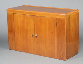 A 1930's oak Art Deco sideboard with raised back fitted a cupboard enclosed by panelled doors 79cm h x 122cm w x 46cm d 