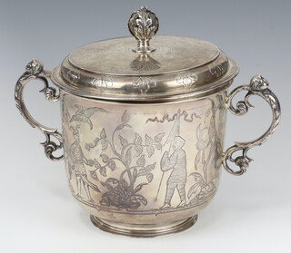 An impressive engraved silver cup and cover with floral and warrior decoration, London 1928, 1292 grams, maker Richard Comyns 