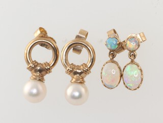 A pair of yellow metal opal set earrings together with a yellow metal pair of pearl drop earrings, gross weight 4.2g 