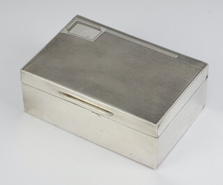 A silver cigarette box with engine turned decoration London 1934 5cm x 13cm x 9cm 