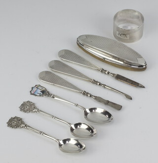 A silver napkin ring with engine turned decoration and inscription Birmingham 1974, 3 silver souvenir spoons and a 4 piece silver backed manicure set Birmingham 1926, weighable silver 62 grams 