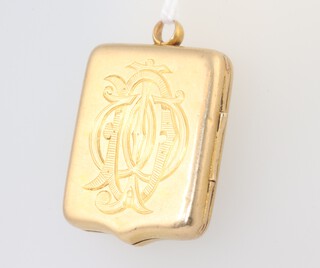 A yellow metal, stamped 18ct shield shaped photo locket, monogrammed, 11.3 grams 