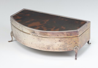 An Art Deco silver and tortoiseshell bow front trinket box with hinged lid, raised on scrolled supports 7cm x 19cm x 10cm 