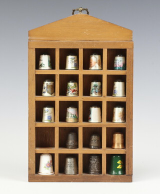 Two silver thimbles, 12 enamelled thimbles and 5 others, all contained in a display case 