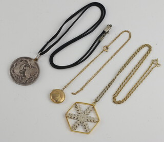 A yellow metal locket hung on a fine yellow metal chain, a 925 pendant in the form of a snow flake hung on a 925 chain and a pendant decorated doves 
