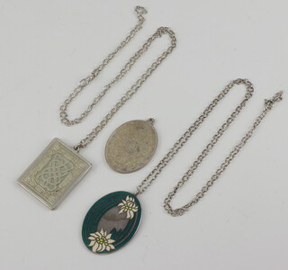 A 1977 rectangular silver pendant with Celtic design marked St Valentine's Day 1977 hung on a silver chain, an oval silver pendant decorated roses, a silver and enamelled pendant with floral decoration hung a silver chain, 92.2 grams 