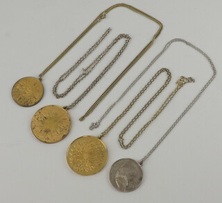 A 1976 Sterling United Nations medallion hung on a fine chain, a 925 gilt pendant and chain and two other pendants 