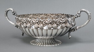 An oval embossed silver plated twin handled bowl raised on a spreading foot decorated strawberries 15cm h 