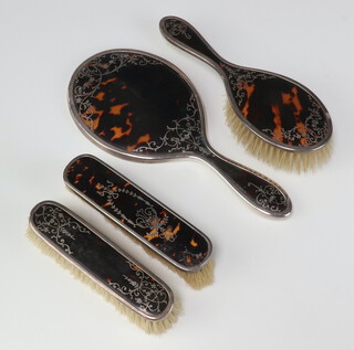 A matched silver and tortoiseshell 4 piece dressing table set comprising hand mirror, hair brush and pair of clothes brushes  