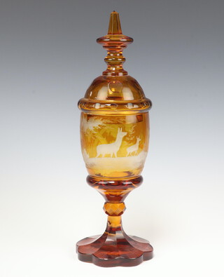 A 19th Century Bohemian amber glass jar and cover decorated stag and deer 37cm h 