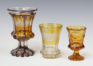 A 19th Century Bohemian amber glass hexagonal panelled goblet with etched building decoration 17cm (chip to rim)  a similar goblet with panelled decoration etched buildings 11cm (chips to base) and 1 other similar 11cm 