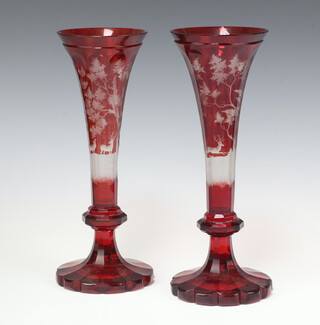 A pair of Bohemian red overlay glass trumpet shaped vases decorated stags 30cm 