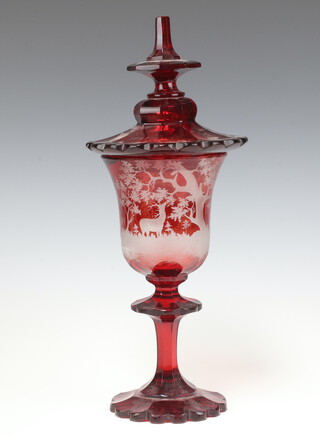 A Bohemian red overlay glass jar and cover decorated a stag  38cm
