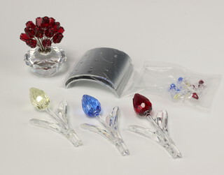 Three Swarovski Crystal  models of tulips 9cm, ditto vase of tulips 6cm and a collection of loose Swarovski Crystal  tulips and stands, all boxed 