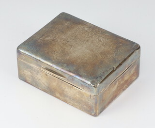 A plain silver cigarette box with hinged lid London 1922 5cm x 11cm x 9cm 