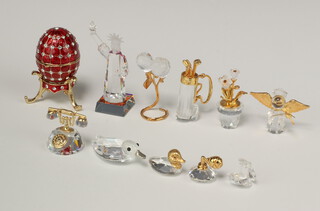 A collection of Swarovski Crystal figures -  duck 4cm, balloon group, clam and pearl, Statue of Liberty, 6 glass and gilt figures and a gilt metal model of and egg and stand 4cm