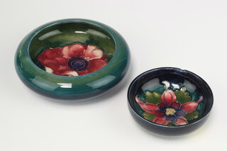 William Moorcroft a dish decorated with anemone with impressed and signature mark 10cm and a blue ground bowl decorated clematis 8cm  