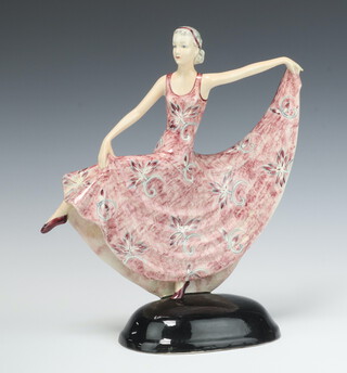 An Art Deco pink glazed pottery figure of a standing dancing lady 31cm h x 28cm 