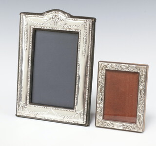 A modern embossed 925 standard  easel photograph frame 11cm x 8cm, together with a silver photograph frame 20cm x 13cm 
