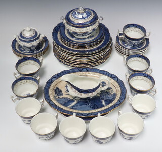 A  Boothes Real Old Willow  pattern 46 piece tea and dinner  service comprising 6 dinner plates 26cm (3 cracked), 4 breakfast plates 25cm (1 cracked), 2 soup bowls 24cm, 5 tea plates 18cm (2 cracked), a side plate 17cm, 5 twin handed soup bowls and 5 saucers (4 bowls and 5 saucers cracked), twin handled sauce tureen, oval meat plate 21cm (cracked), bread plate 25cm, sauce boat, lidded sugar bowl and 6 Royal Doulton tea cups & 7 saucers (1 cracked)