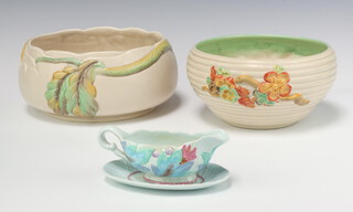 A Clarice Cliff circular bowl 20cm, 1 other with floral decoration 19cm and a sauce boat and stand (cracked) 15cm 