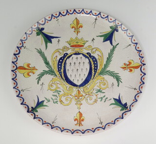 A circular pottery charger with armorial decoration 35cm 