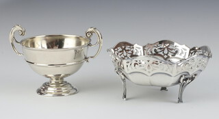 A silver twin handled trophy cup London 1911 together with a circular silver bowl with pierced decoration raised on panelled supports London 1926, 219 grams 