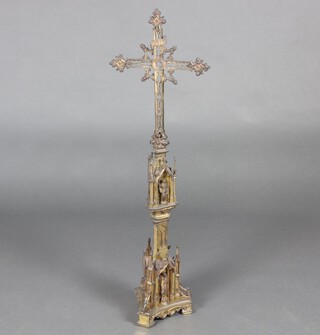 A Gothic pierced gilt metal cross raised on a triform base 106cm h x 33cm w x 20cm d 