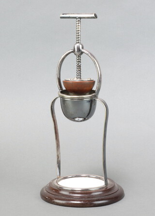 A 19th Century silver plated and mahogany lemon squeezer with ceramic tile to the base 33cm x 15cm 