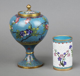 A Japanese cloisonne blue ground globular shaped jar and cover, raised on a waisted column decorated butterflies 18cm together with a cylindrical spill vase 6cm 