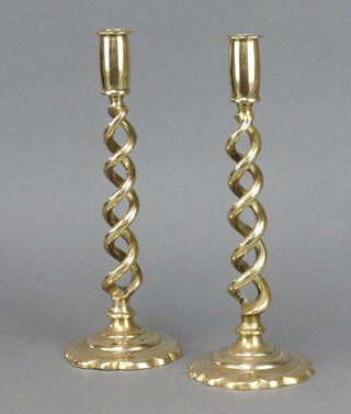 A pair of Victorian brass spiral turned candlesticks on petal bases 29cm 