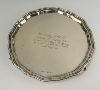 A silver salver with bracketed border raised on scroll supports Sheffield 1934, 26cm, with presentation inscription, 572 grams 