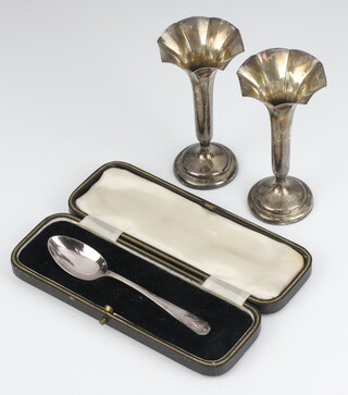 A pair of silver trumpet shaped specimen vases Birmingham 1912 on a spreading foot 11cm, together with a National Honey Show silver plated spoon cased 