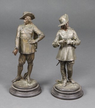 A pair of Victorian spelter figures of standing cavaliers on circular bases 44cm h 