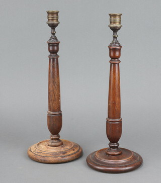 A pair of 1930's turned oak candlesticks with metal sconces 38cm x 13cm 