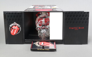 A Rolling Stones crystal head display case containing skull head decanter of vodka, Rolling Stones live CD double album and crystal engraved decanter top 