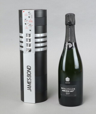 A bottle of James Bond 50th Anniversary Bollinger Champagne, limited edition of 30,000, produced in 2002, the box in the form of a firearm silencer,  containing a bottle of Bollinger La Grande Annee 2002