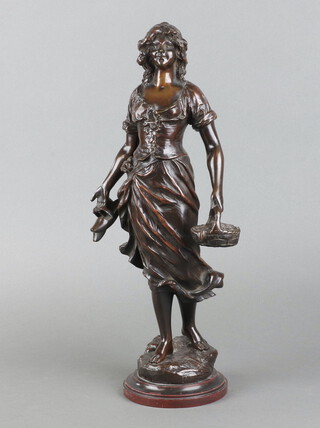 After Leon Perzinka, a bronze figure of a standing lady with basket of fish, raised on a marble base 38cm x 11cm 