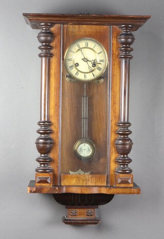 A Vienna style chiming regulator with 12cm celluloid dial, Roman numerals, grid iron pendulum complete with key, contained in a walnut case 66cm x 40cm x 19cm  