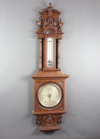 Joseph Somalvico & Co., a large and impressive Victorian mercury barometer and thermometer, the 25cm dial marked Joseph Somalvico & Co, 16 Charles St, Hatton Garden, London, contained in a heavily carved oak case with griffins, lidded urn finials, 141cm h x 43cm w x 10cm d 