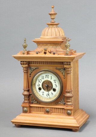 The Greenwich Clock, Hamburg American Clock Co. a striking mantel clock with 10cm enamelled dial, Roman numerals contained in a carved bleached walnut case, complete with pendulum and key  